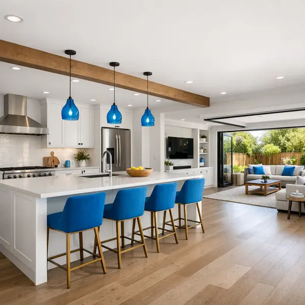 Spacious open-plan kitchen and living area created by a modern home addition, featuring bright natural light and seamless flow.