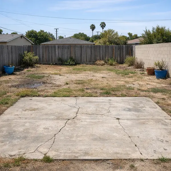 Outdated Tarzana backyard with aging concrete, patchy grass, and poor layout before backyard transformations